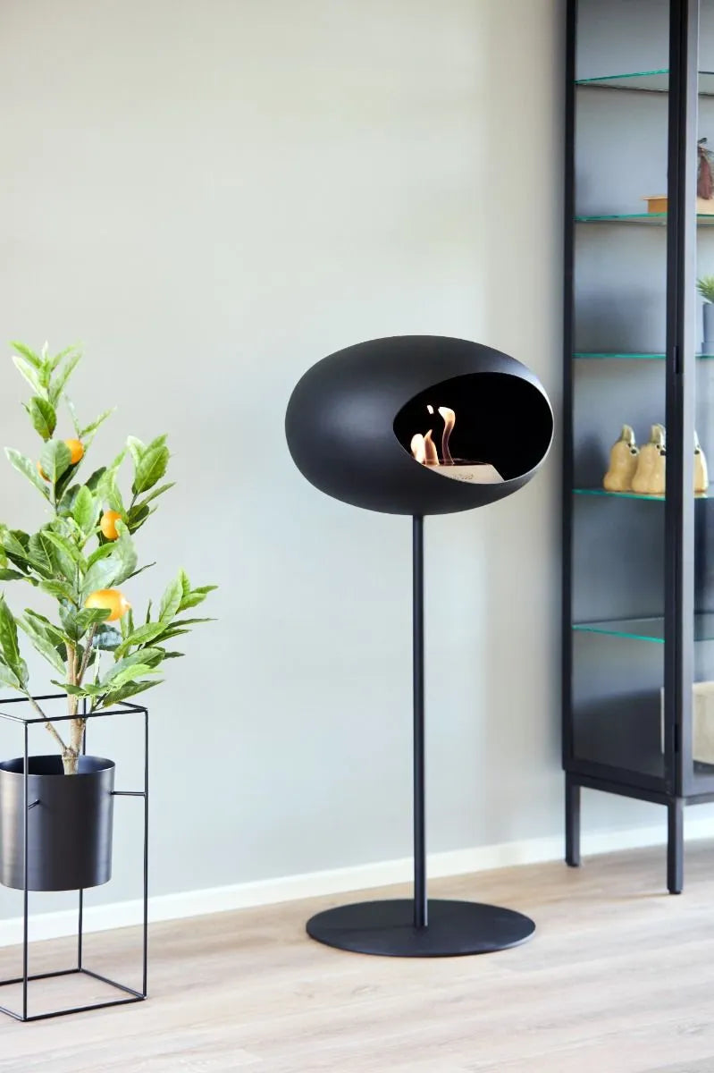 Freestanding black bioethanol fireplace Le Feu Dome, modern design, perfect for indoor and outdoor spaces.