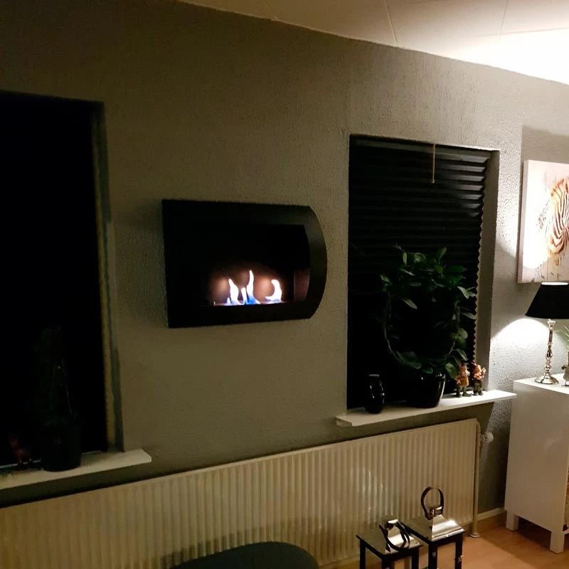 Stylish black wall-mounted bio fireplace with flames glowing, enhancing contemporary living space decor.