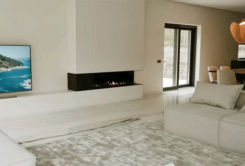 Modern living room featuring DALEX Touch 1000 bioethanol fireplace, minimalist decor, and large windows for natural light.