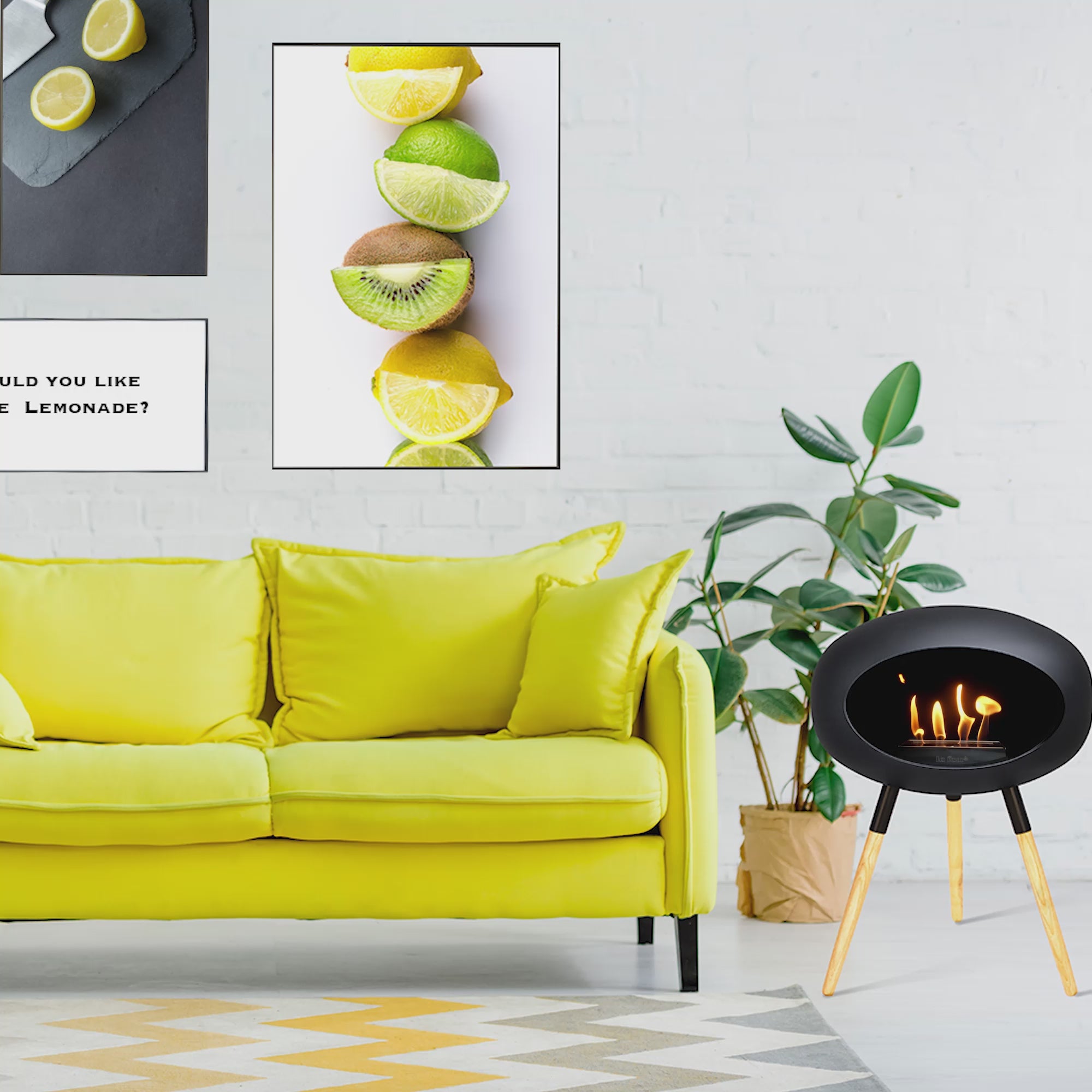 Le Feu Dome Ground Low bioethanol fireplace in black beside a vibrant yellow couch and green plant.