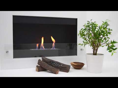 Nebraska White wall mounted bioethanol fireplace with safety glass, flames, and decorative plant nearby.