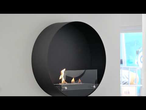 Round wall mounted black bioethanol fireplace with safety glass, elegant design for contemporary interiors.