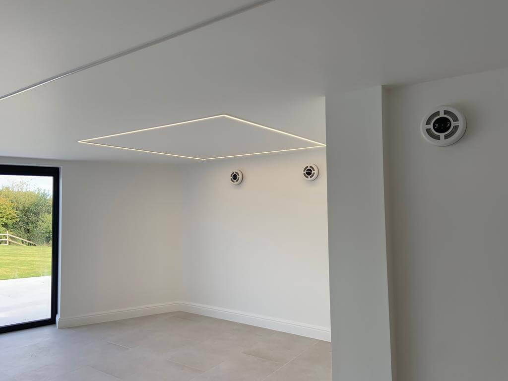 Modern room featuring a heat recovery ventilation system with discreet vents for optimal air quality.