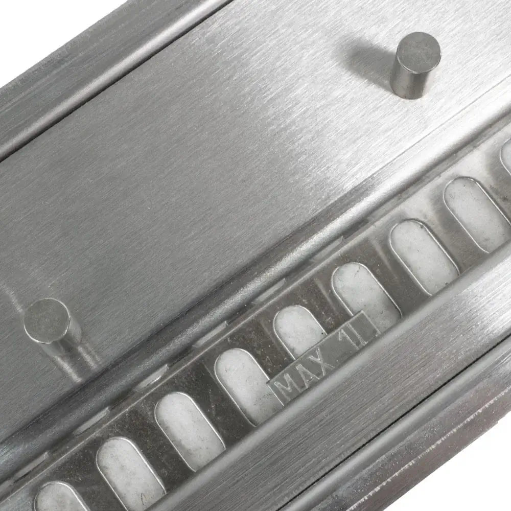 Close-up of stainless steel bioethanol burner with max fill indicator and slots for fuel.