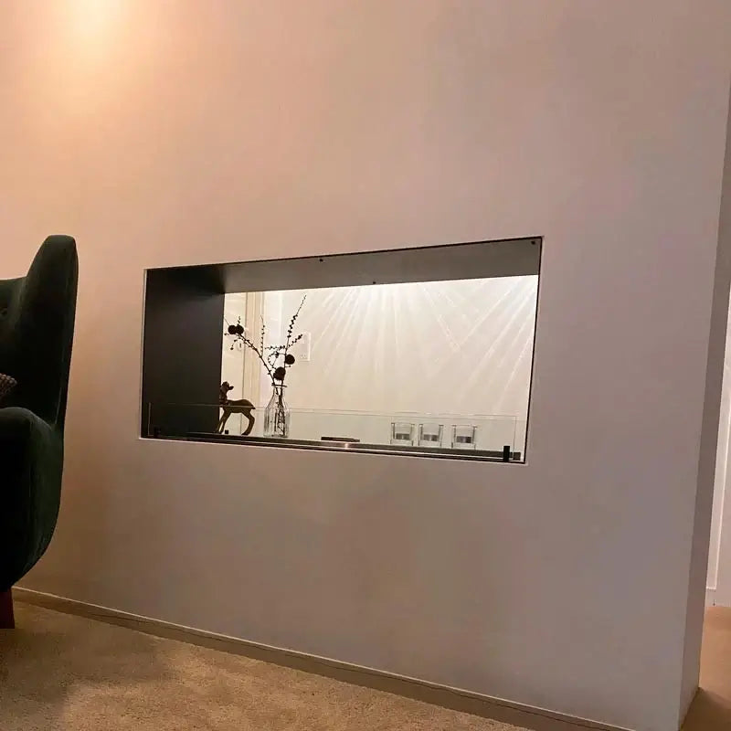 Built-in bioethanol fireplace insert integrated into modern wall design, featuring a sleek frame and decorative elements.