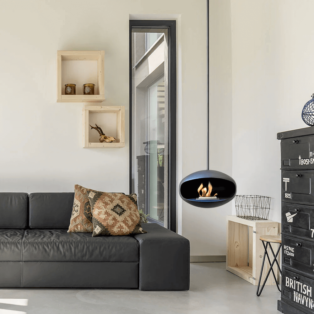 Cocoon Aeris matte black bioethanol fireplace suspended in modern living room with stylish decor.