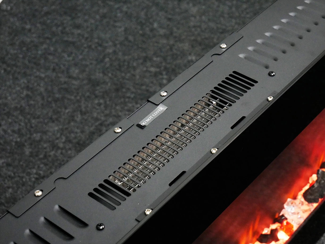 Top view of ScandiFlames Azurite wall-mounted electric fireplace heater, showcasing ventilation and flame design.