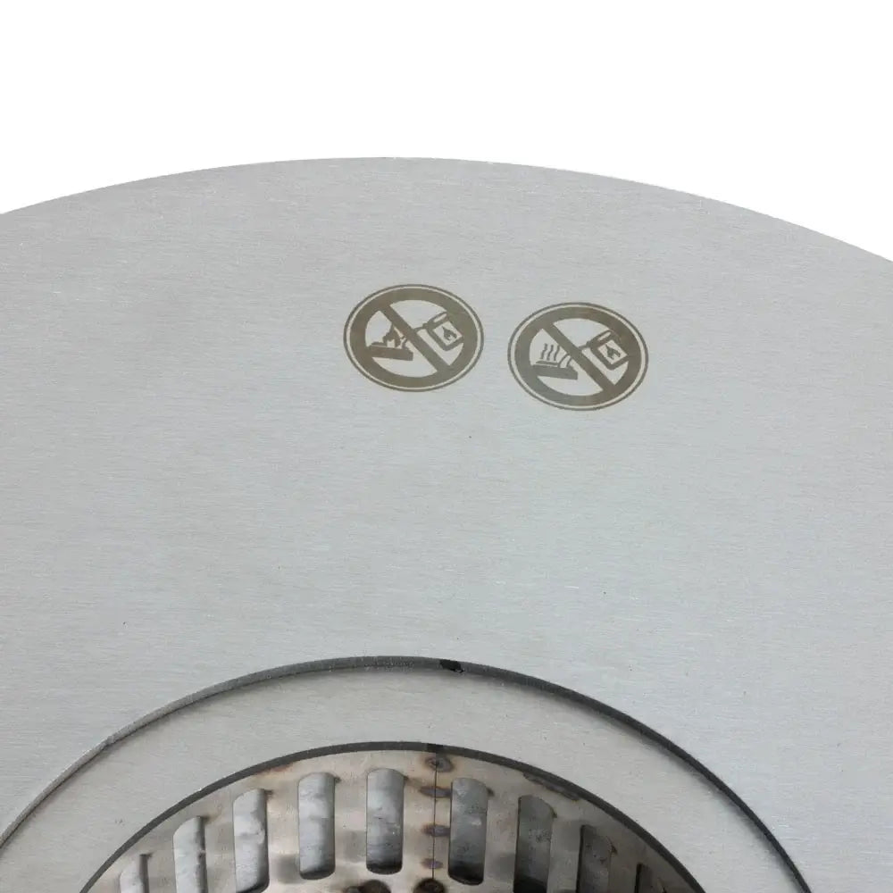 Safety symbols on a large round bioethanol burner indicating no flammable materials and caution for use.