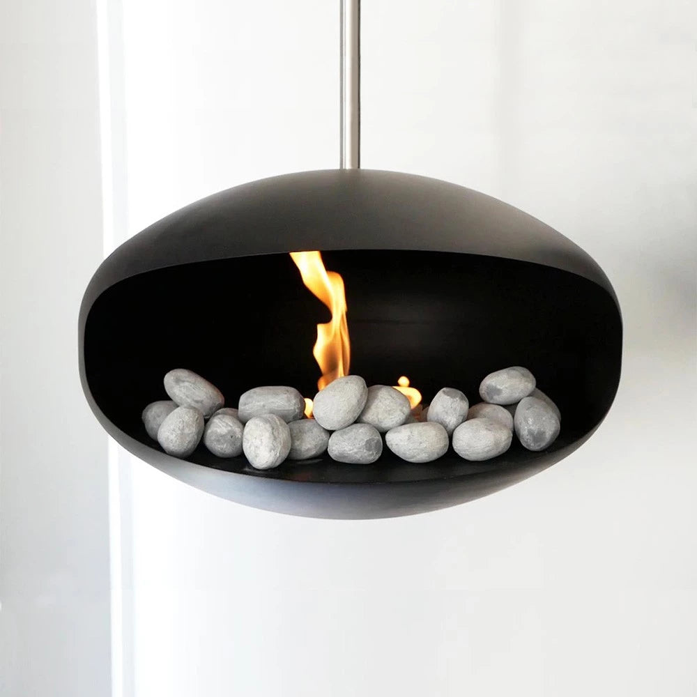 Modern hanging bio fireplace with grey ceramic pebbles and visible flames, enhancing indoor decor.