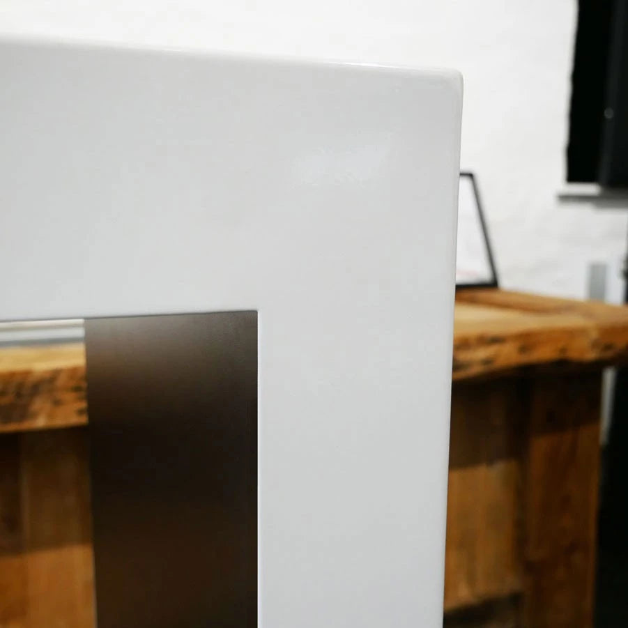 Close-up of the Lansing bioethanol fireplace's sleek white frame and stainless steel accent, showcasing modern design.