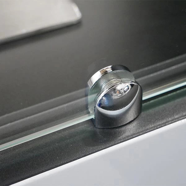 Close-up of chrome bracket securing glass panel for Lansing bioethanol fireplace.