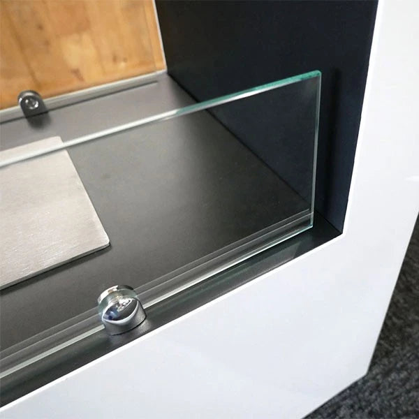 Close-up view of the glass panel on the Lansing freestanding bioethanol fireplace with sleek design features.