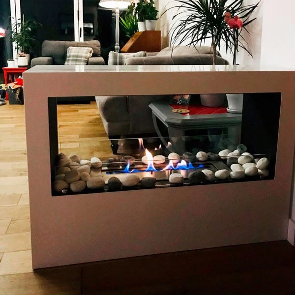 Lansing bioethanol fireplace with glass front, pebbles, and vibrant flames, perfect as a room divider.