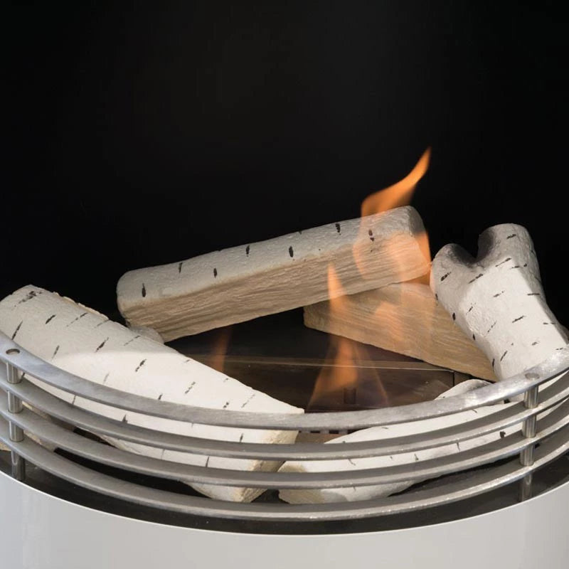 Ceramic birch logs in a bio fireplace, adding decorative touch to the flames for cozy ambiance.