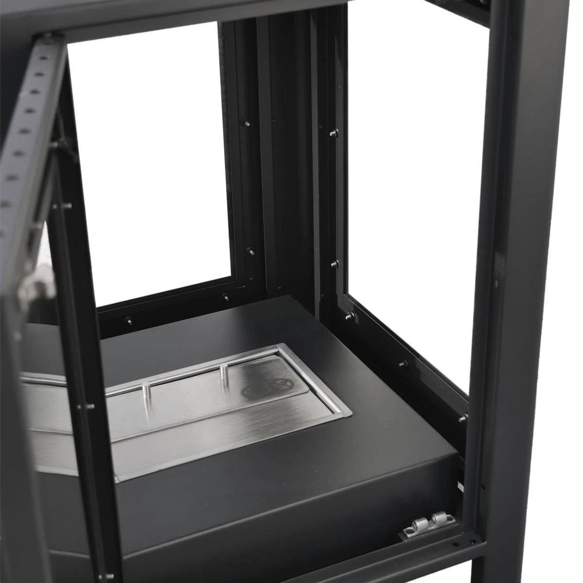 Interior view of the Natura garden fireplace showing the burner and durable stainless steel base.