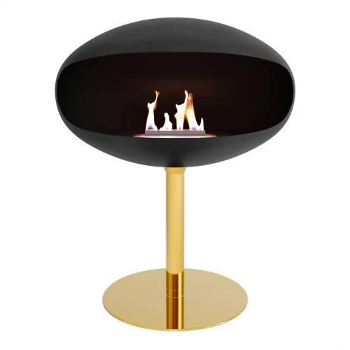 Cocoon Pedestal Black free-standing bioethanol fireplace with brass base and flames.