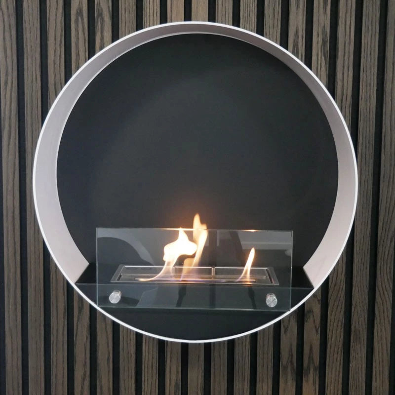 Delaware White round wall mounted bioethanol fireplace with orange flames on a black background.